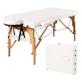 A pristine white massage table with a matching cover, designed for comfort and relaxation in a therapeutic setting.